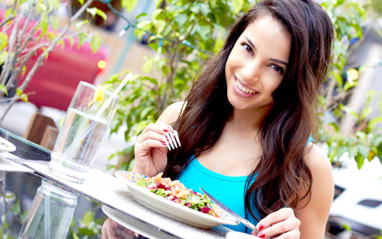 Young Attractive Woman Eating Salad